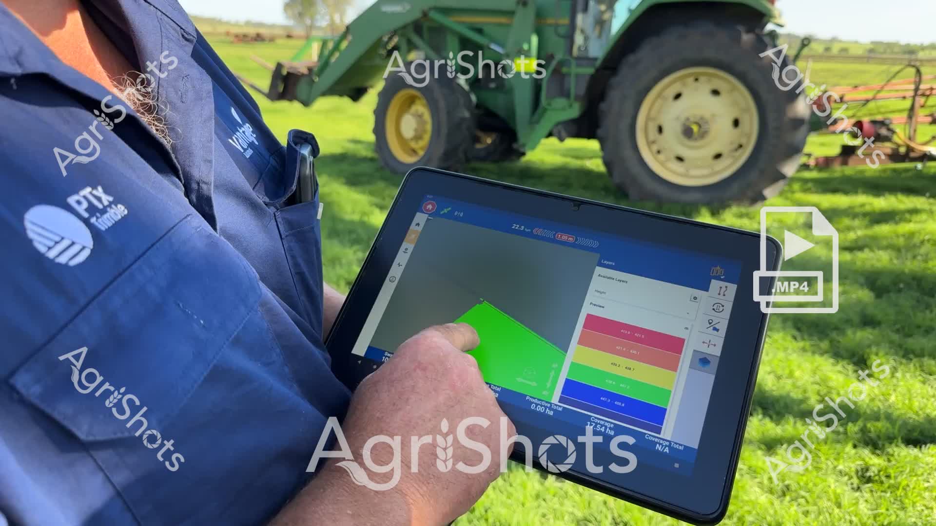 A professional agricultural technologist uses advanced digital mapping technology to monitor farm operations in a lush green paddock. Wearing a navy blue uniform with various agricultural technology logos, the technologist carefully navigates a digital tablet displaying a sophisticated field mapping interface. A green John Deere tractor sits in the background, highlighting the integration of modern precision agriculture technologies. The tablet screen shows detailed green and colored zones, suggesting crop monitoring or field management software. The scene captures the cutting-edge intersection of digital technology and traditional farming, demonstrating how modern agricultural professionals use sophisticated digital tools to enhance farm productivity and efficiency. The green grass and bright daylight create an optimistic atmosphere of technological innovation in agriculture.

The image is categorized under:
- Farm Equipment
- Agricultural Equipment
- Crops & Harvest
- AI Description Feedback
- Technology
