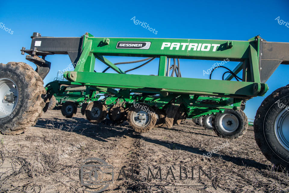 Gessner's Patriot air cart stands resolute against a crystalline Queensland sky, a verdant green agricultural marvel poised for precision planting. Robust wheels grip the dry, textured earth, revealing the rugged terrain of a wheat cropping landscape. The sophisticated seeding equipment showcases modern agricultural engineering, with its complex hydraulic systems and structured frame designed for maximum efficiency across challenging rural terrain.

Gleaming in sunlight, the air cart's metallic green frame speaks to cutting-edge farming technology, integrating GPS guidance and advanced mechanical design. Multiple wheels provide stability and weight distribution, critical for navigating uneven ground during critical planting seasons. The Gessner Patriot represents the pinnacle of agricultural innovation - a powerful machine bridging human agricultural ambition with precision mechanical capability.

The surrounding environment tells a story of resilience: compacted soil, scattered crop remnants, and an expansive horizon suggesting the vast agricultural heartland of regional Queensland. This image captures the essence of contemporary broadacre farming - technology, scale, and the enduring relationship between farmer and land.